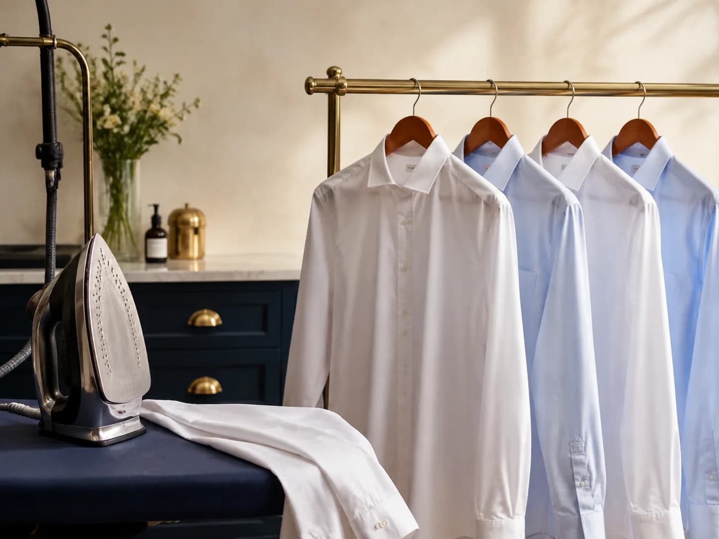 Freshly pressed shirts beside a professional iron